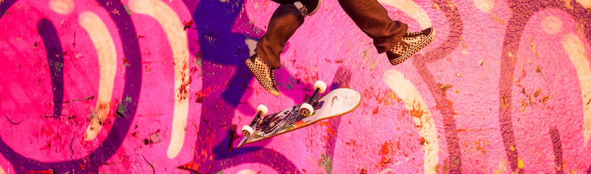 Tony Hawk's character flipping a board mid-air near wall with pink graffiti
