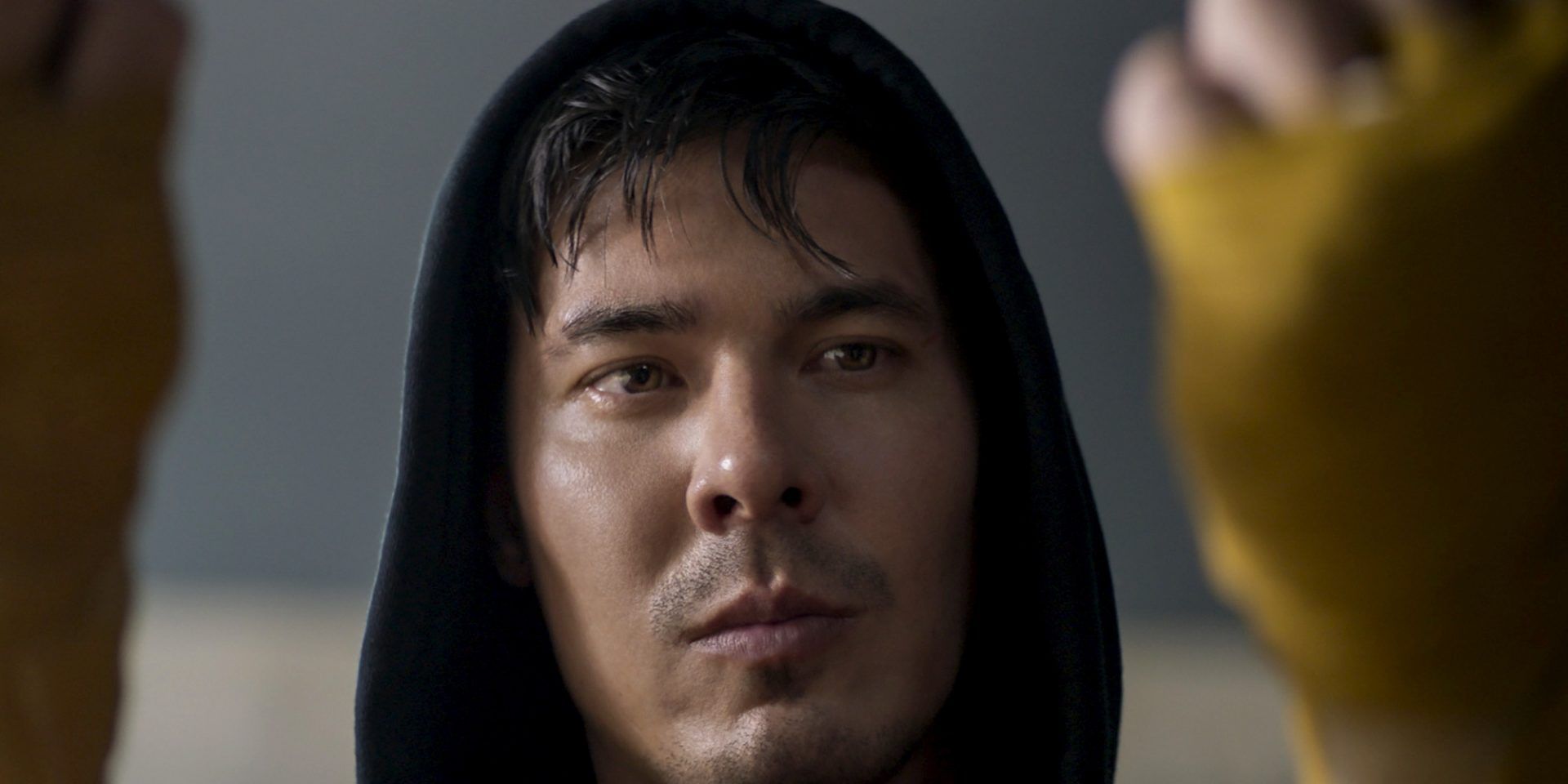 Lewis Tan as Cole Young Looks Down At His Yellow-Taped Fists Before A Fight In The 2021 Reboot Of Mortal Kombat 