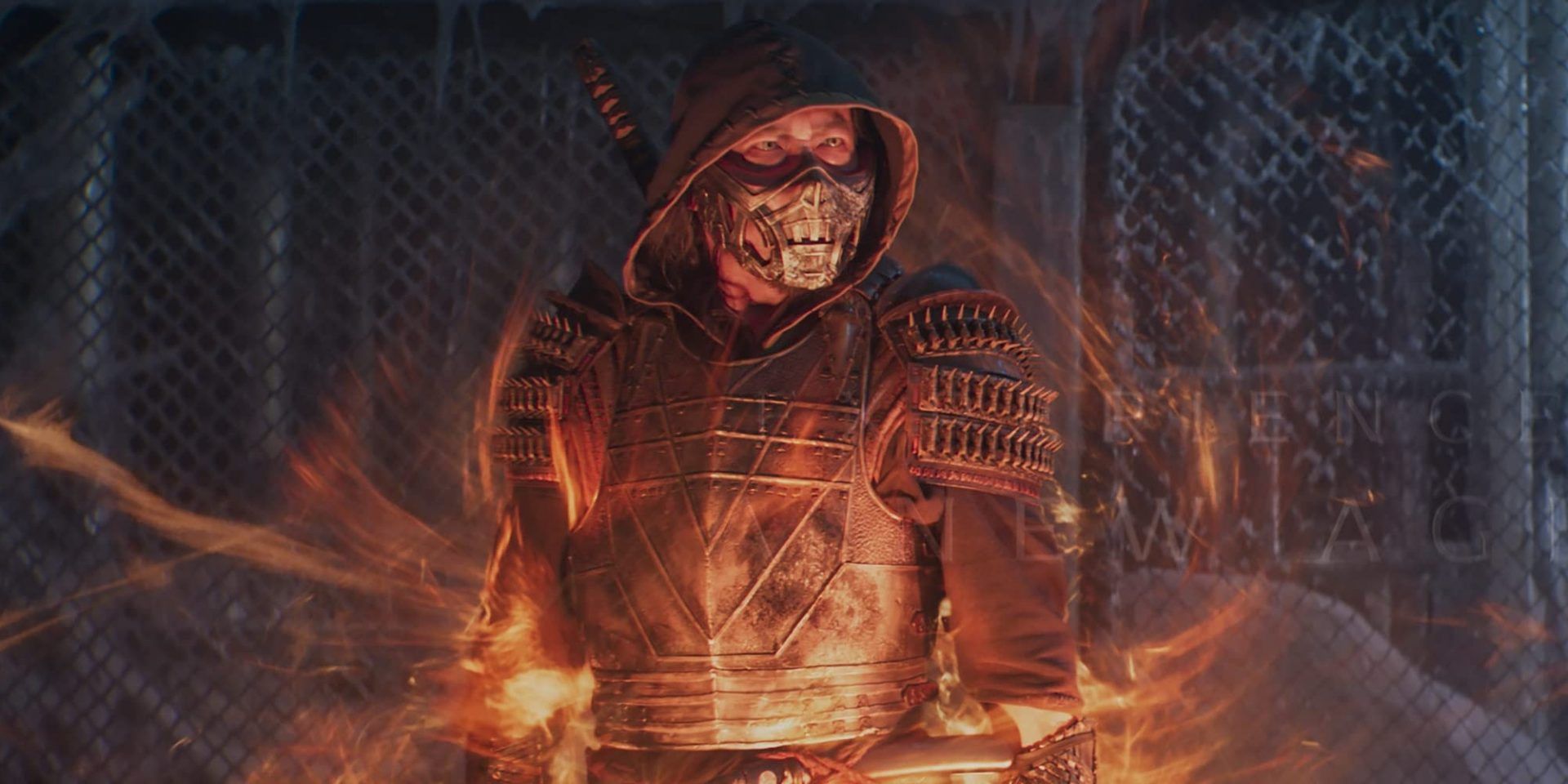 Hiroyuki Sanada as Scorpion in front of an ice-wrapped cage while he is engulfed in fire During A Fight In 2021's Mortal Kombat