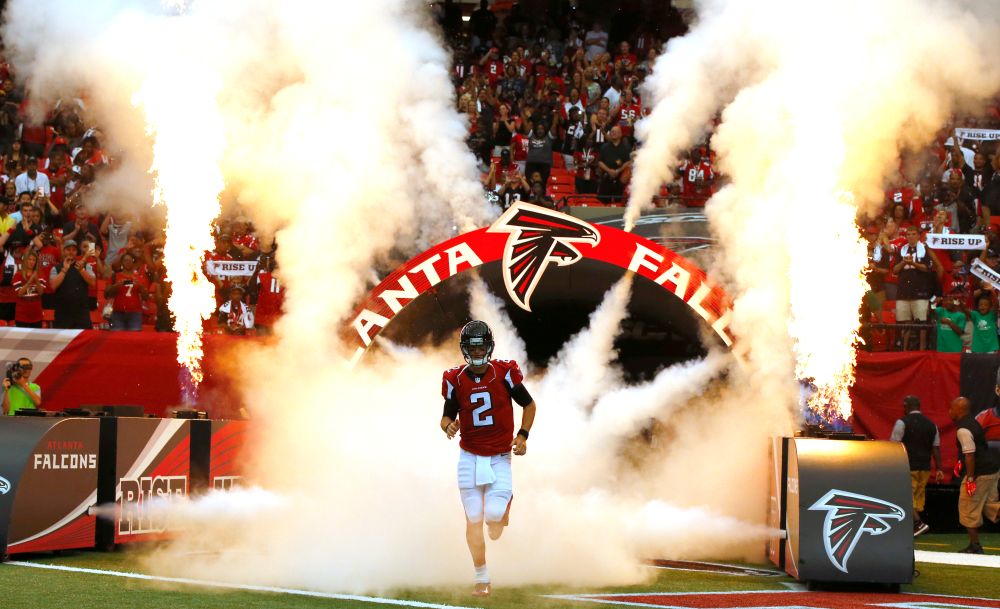 Former Atlanta Falcons Quarterback Matt Ryan runs out onto the field during pre-game introductions