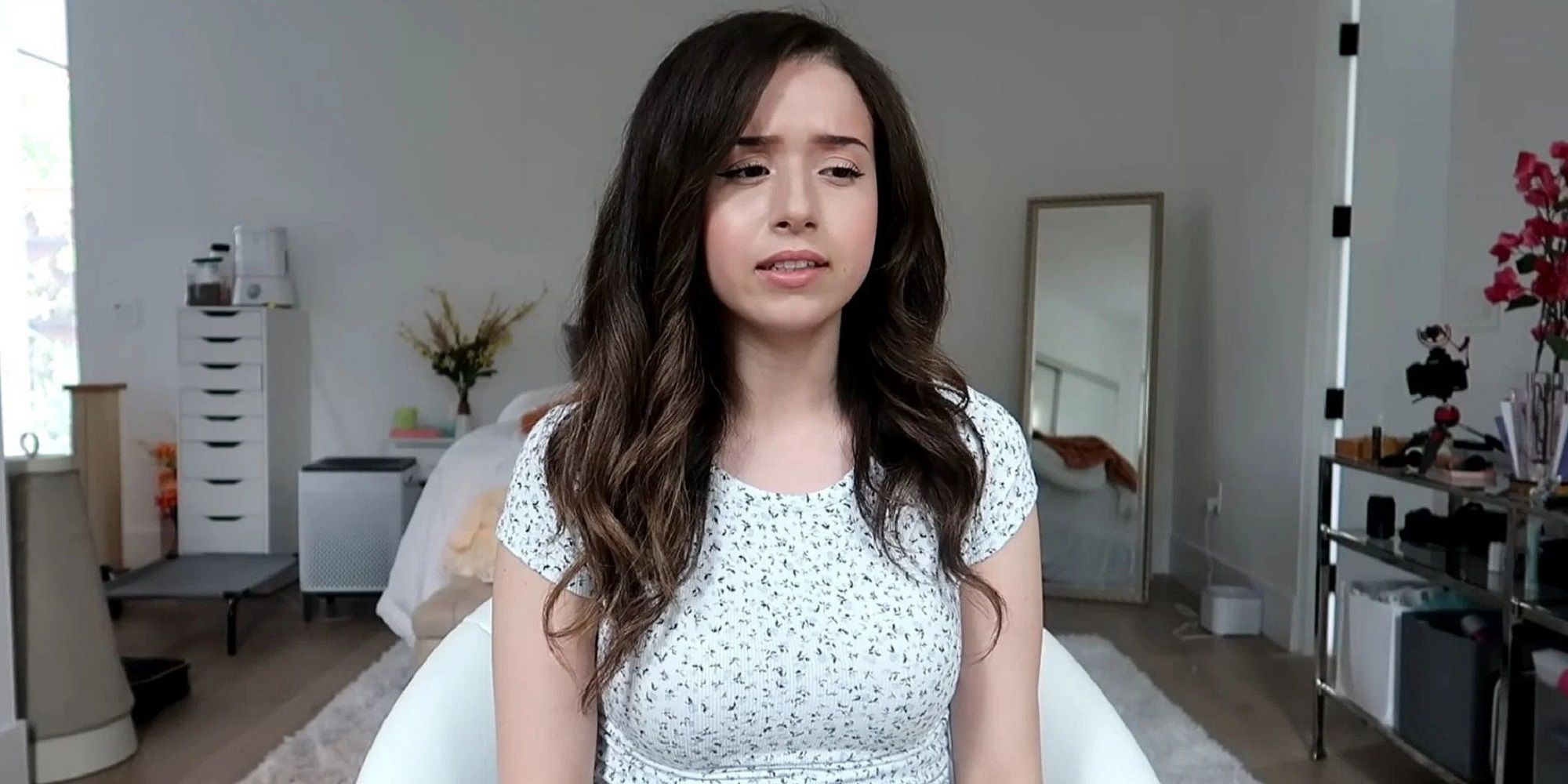 Streamer Pokimane With Serious Expression Wearing White Specked Shirt 
