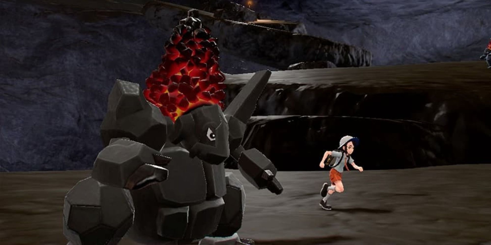 Pokemon Scarlet and Violet screenshot of Coalossal in a cave with player running by