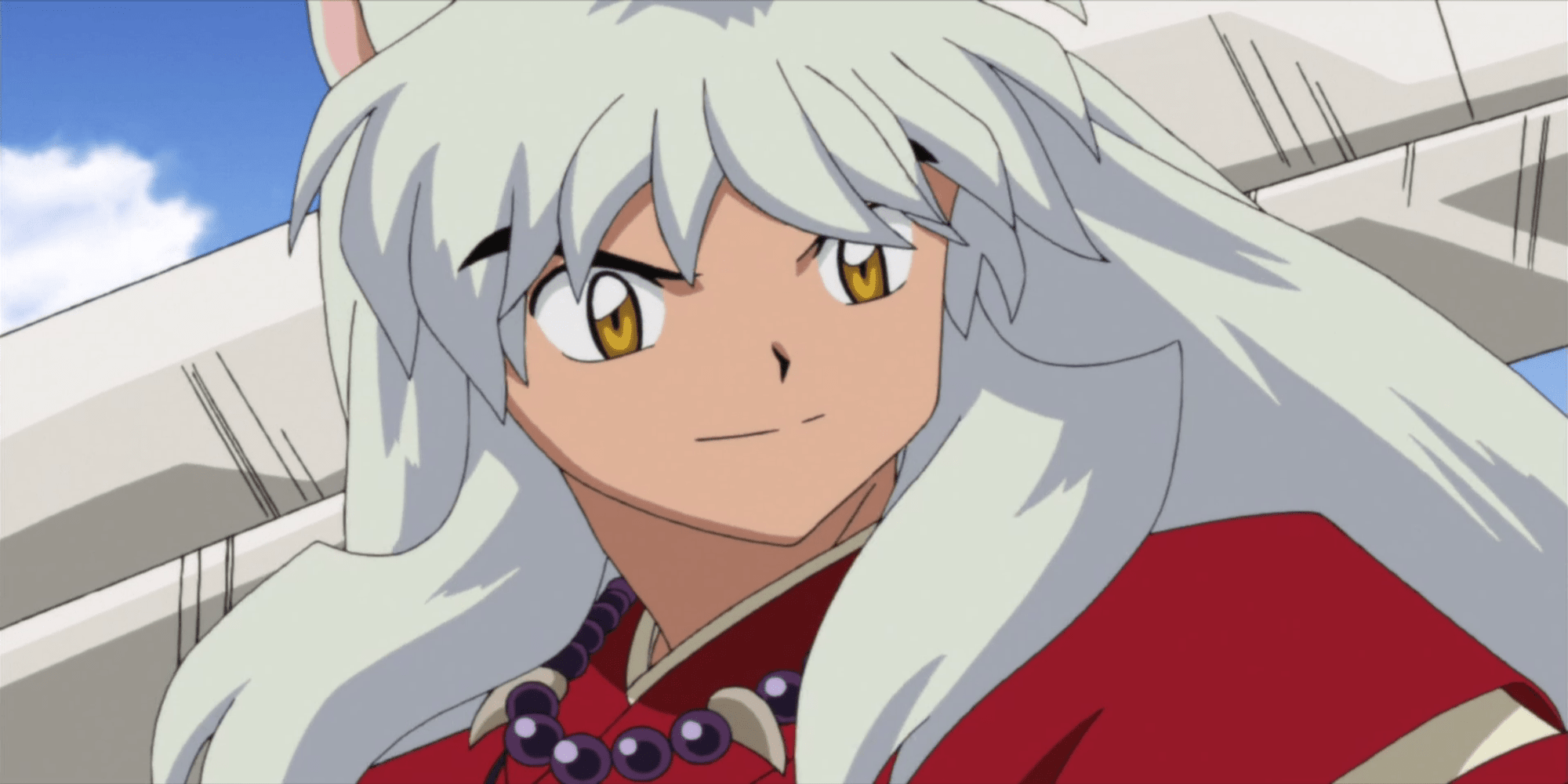 Inuyasha smiling while holding his sword behind his head