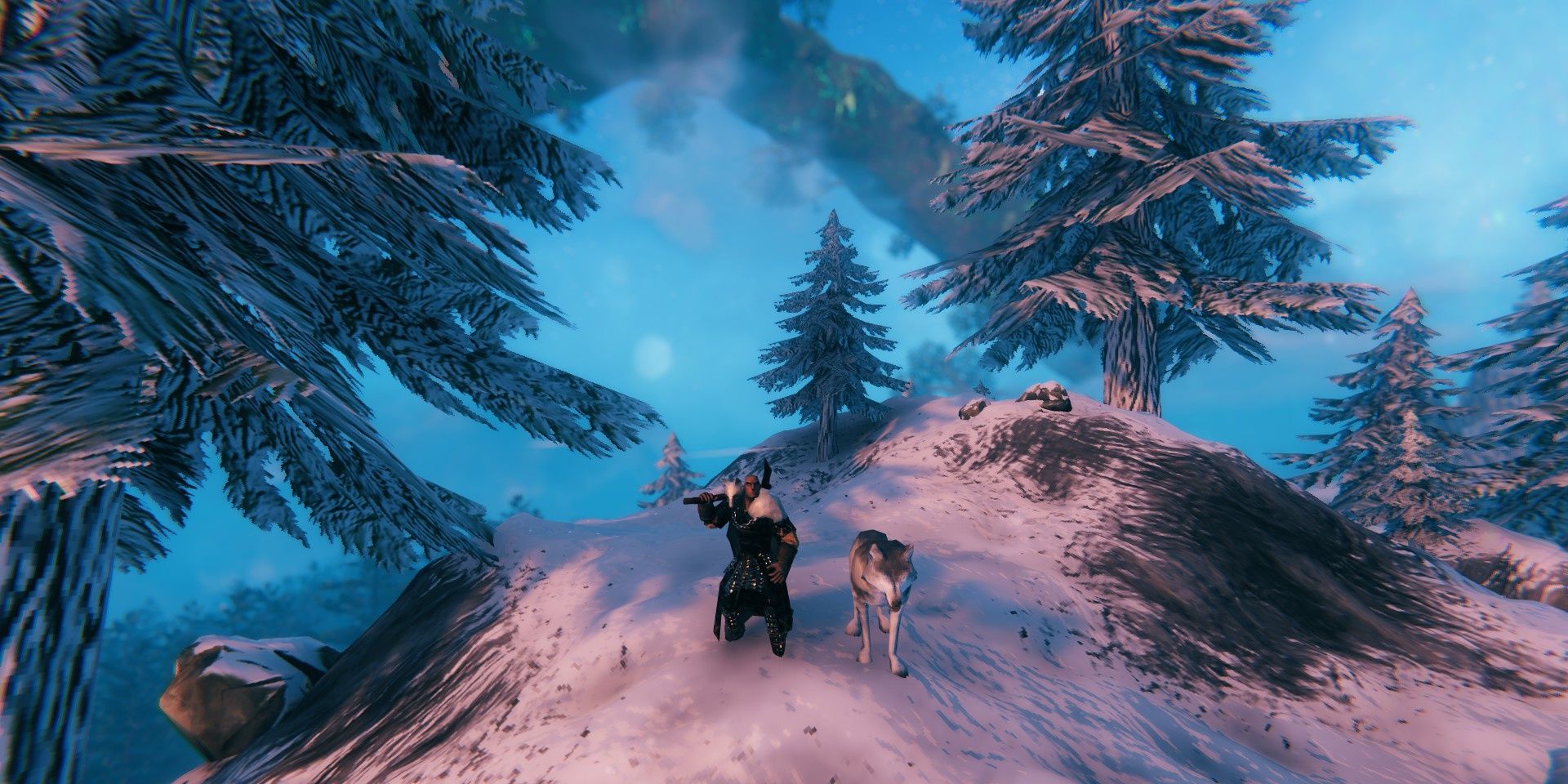 A player stands atop a peak in the Mountains with a Tamed Wolf at their side.