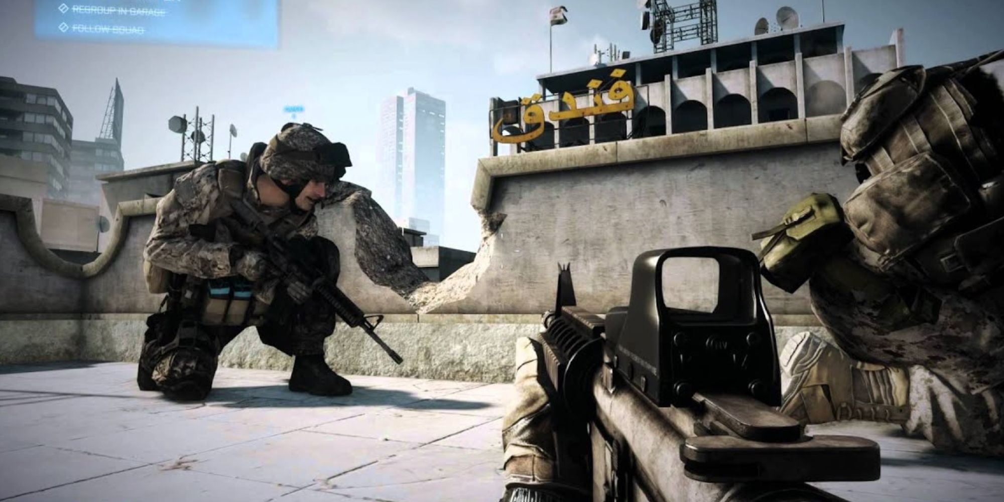 Soldiers crouch behind cover with weapons ready in Battlefield 3 with Arabic looking writing on the one building