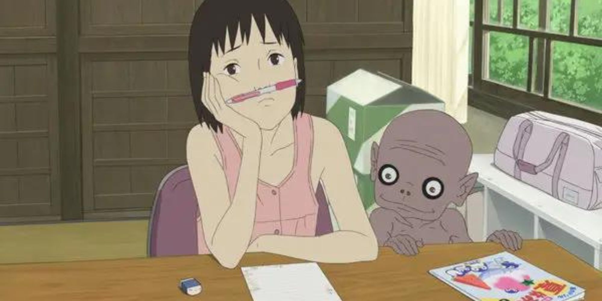 A Letter To Momo protagonist sits at desk