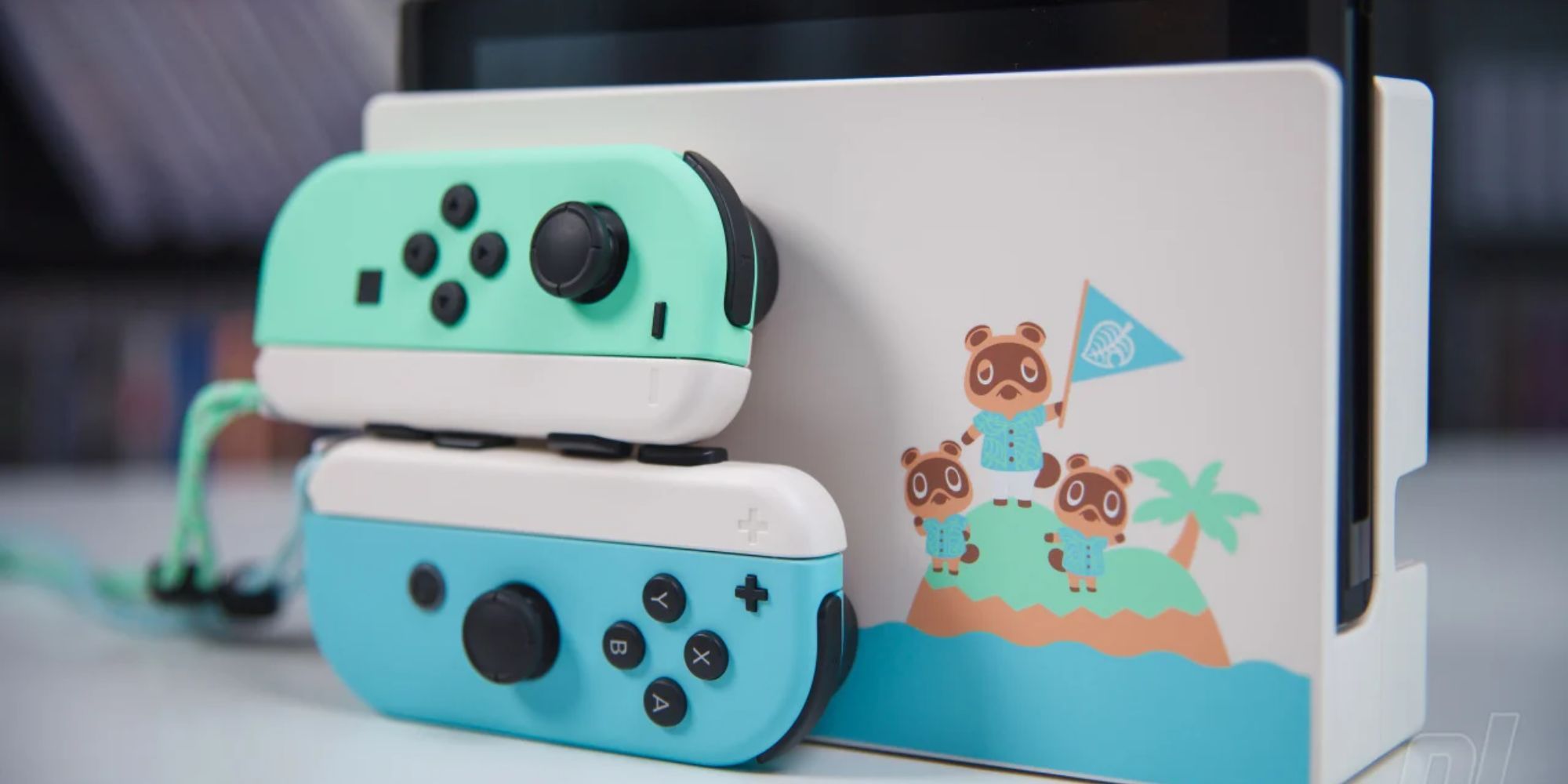 Pastel green and blue Joy Cons with a dock featuring Tom Nook, Timmy and Tommy on the Animal Crossing New Horizons Nintendo Switch
