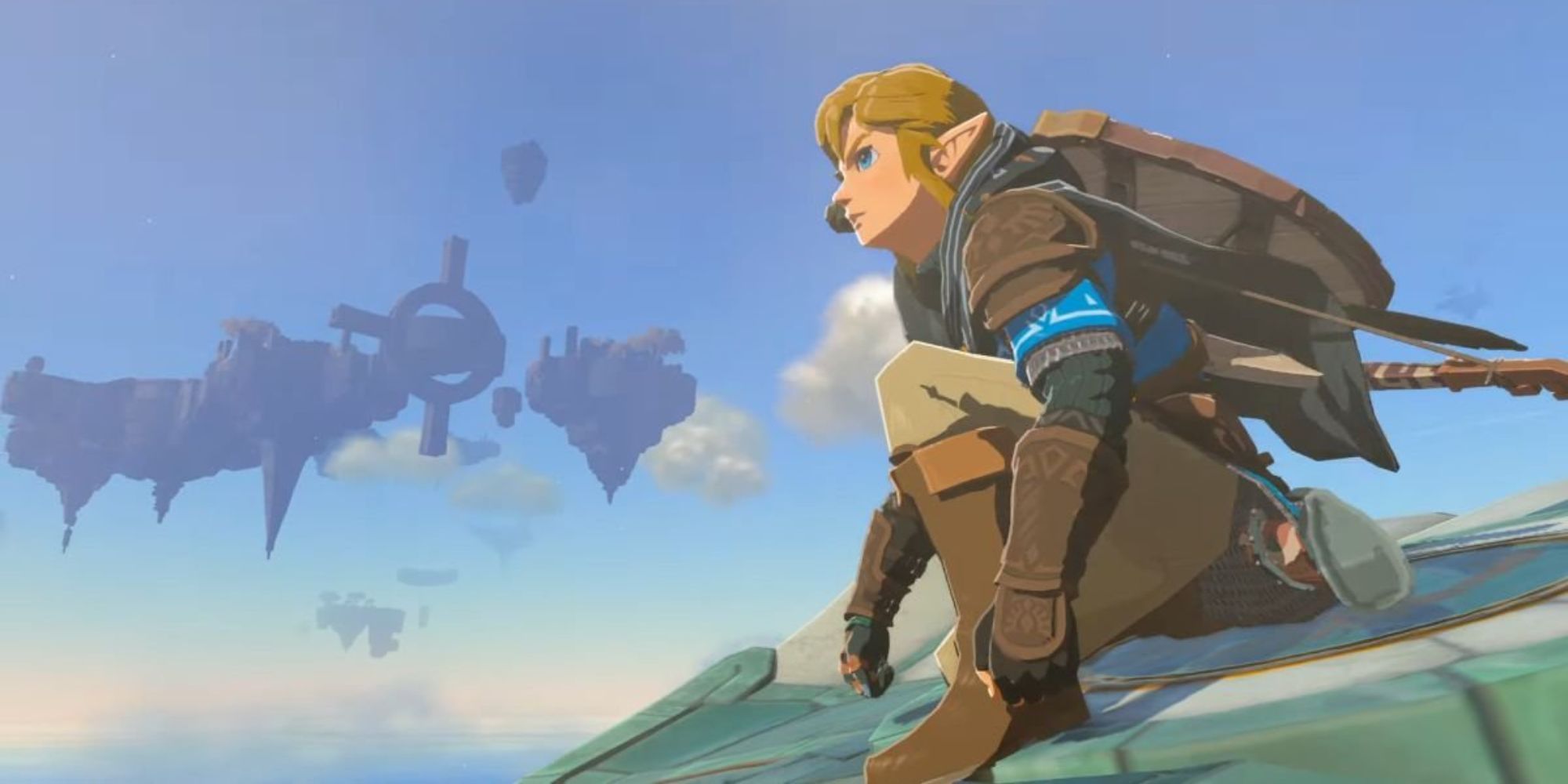 The protagonist Link rides a Zonai Glider next to sky islands in The Legend of Zelda Tears of the Kingdom