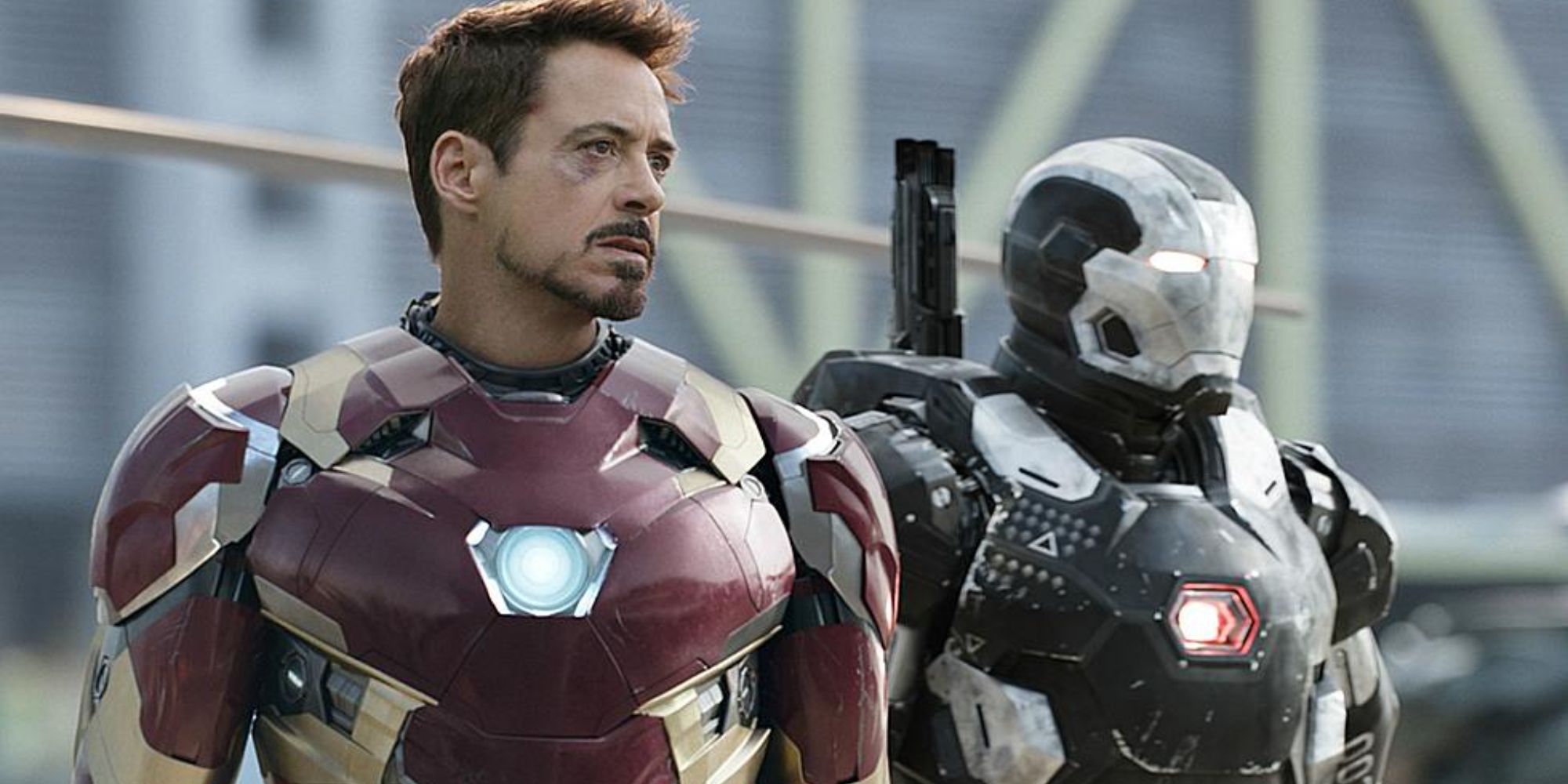 Robert Downey Jr. as Iron Man wearing a red and gold metal suit standing next to War Machine in Captain America: Civil War