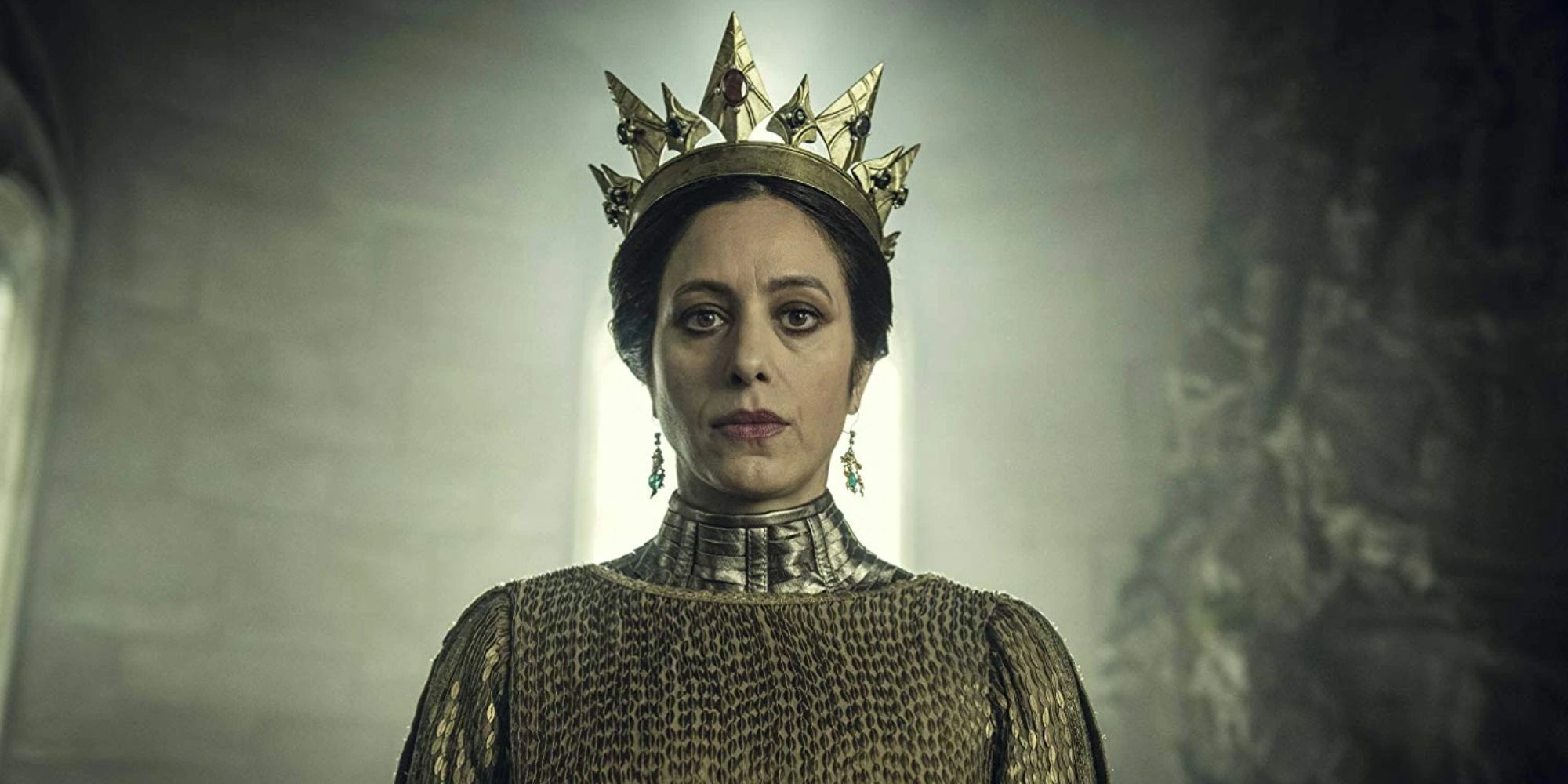 Still of Calanthe wearing a gold crown and dress in The Witcher