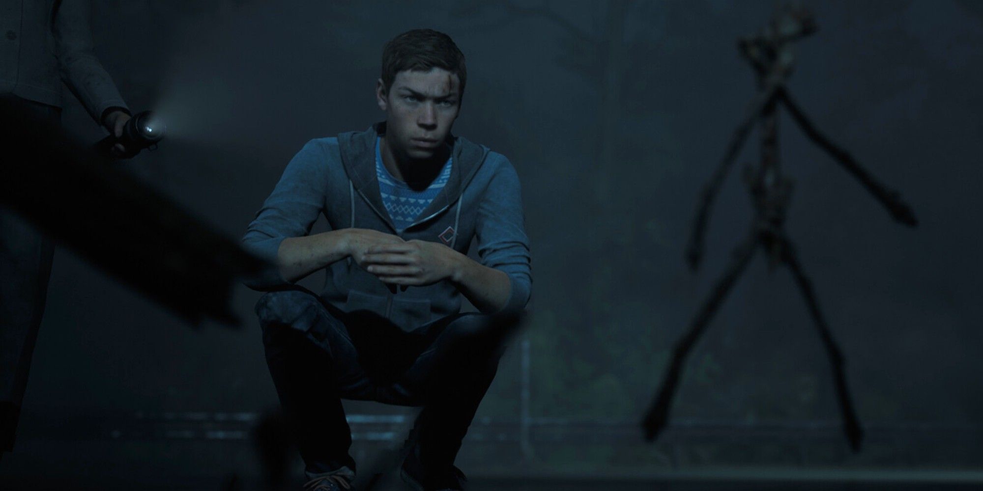 Little Hope Will Poulter Looking At Witch Totems