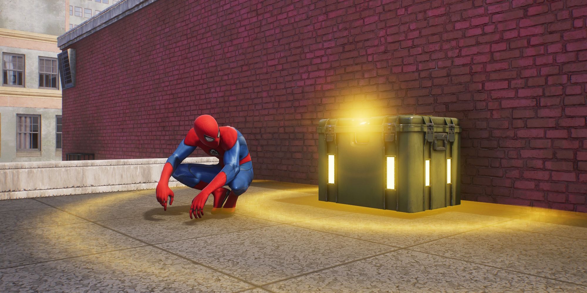 Still of Spider-Man crouched next to a yellow tech crate on a rooftop in Spider-Man 2