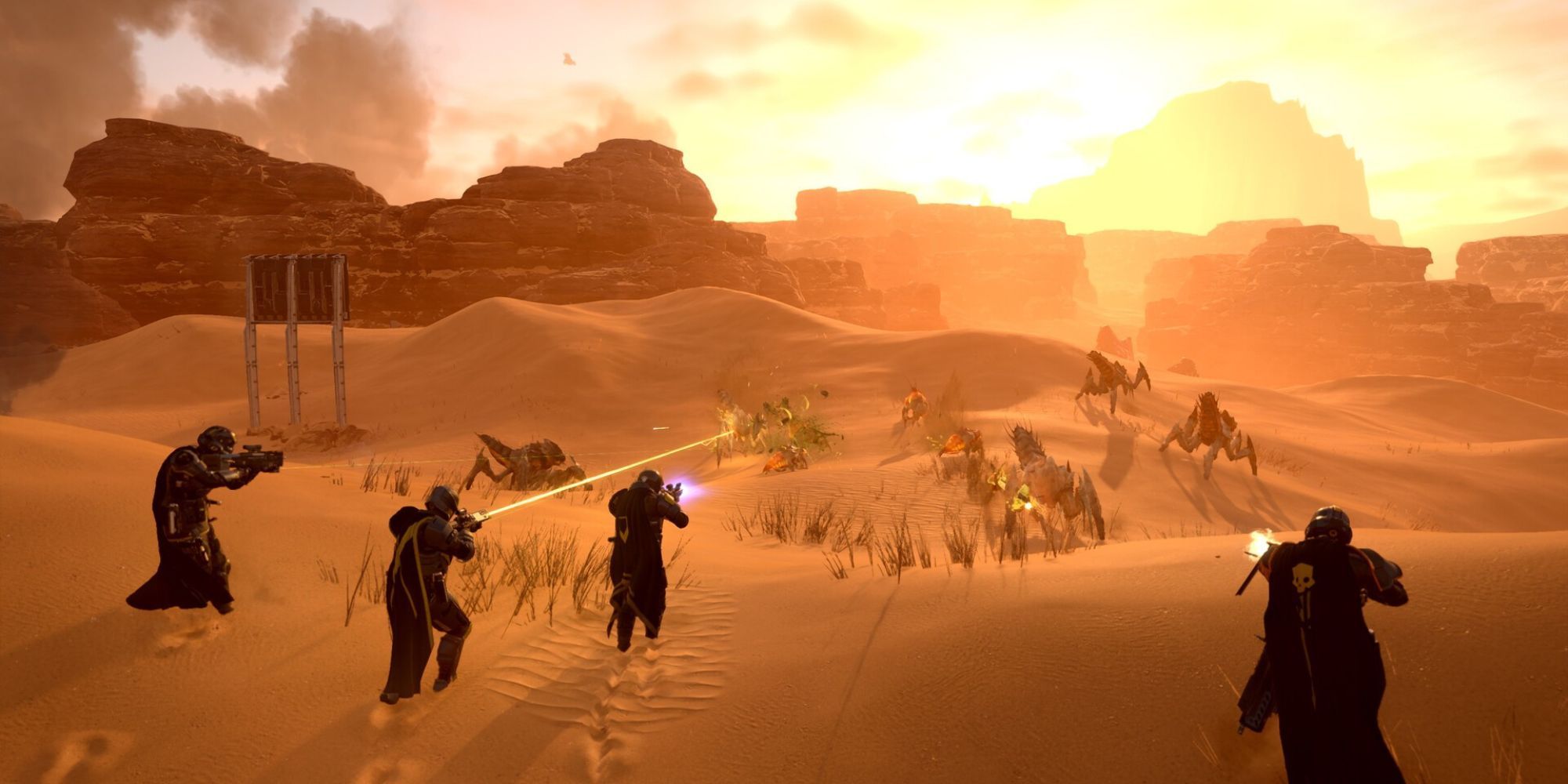 a squad of 4 helldivers fighting terminids on a desert planet