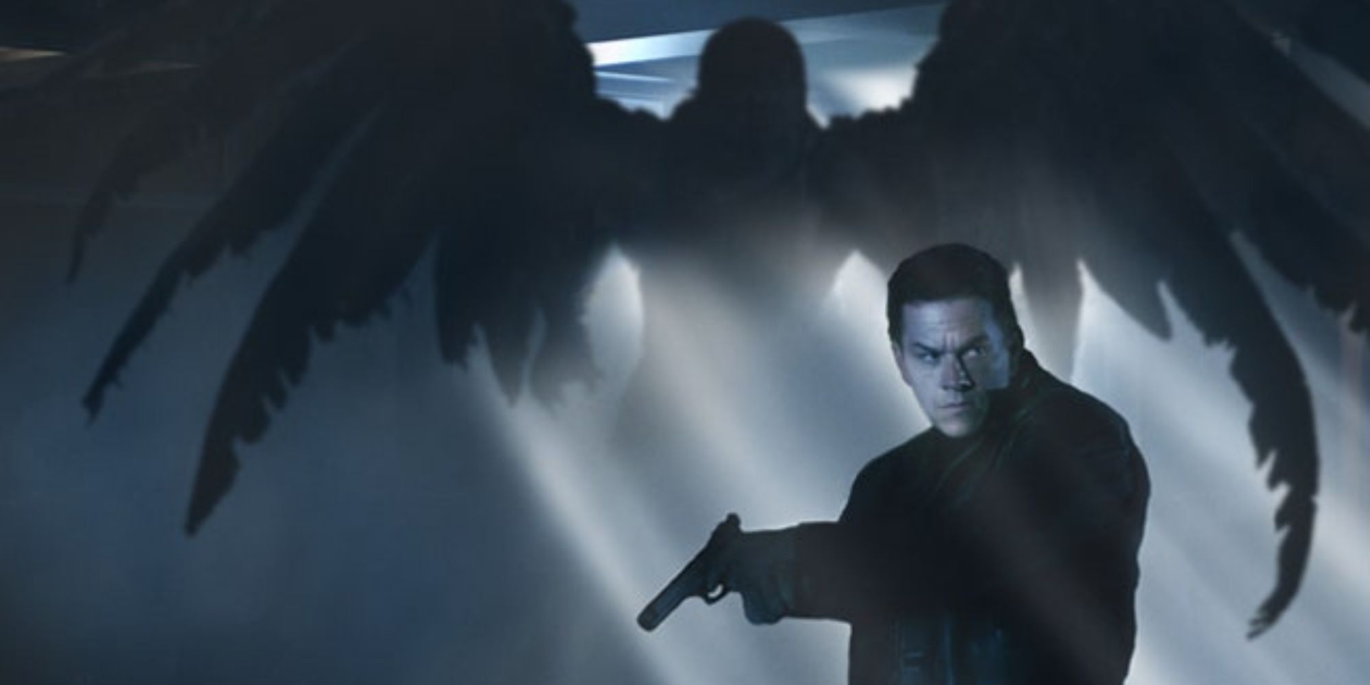 Still from the Max Payne movie of Mark Wahlberg's protagonist standing in front of a winged creature.