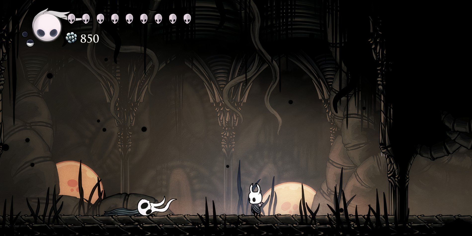 Hollow Knight staring at the defeated body of the Broken Vessel in the Ancient Basin