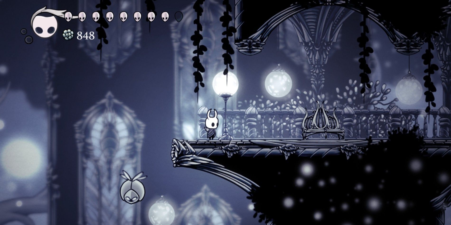 The Knight in Hollow Knight standing near the first bench in the White Palace