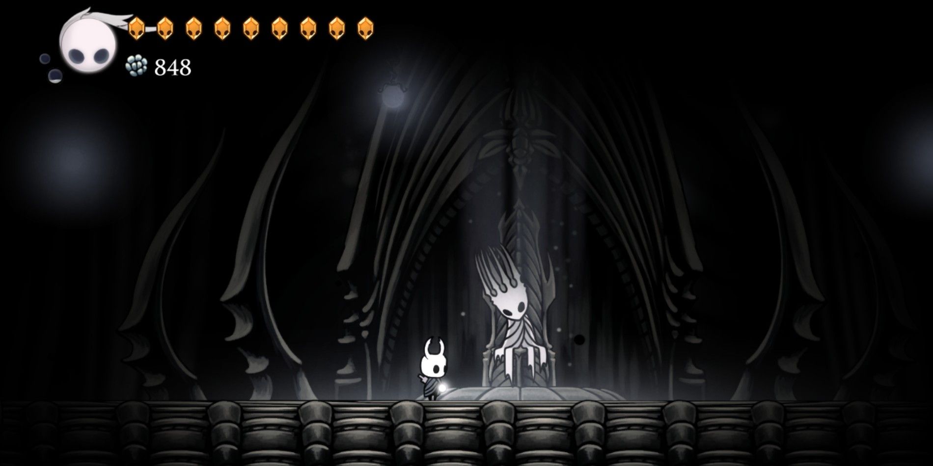 The knight in Hollow Knight in the Throne room of the Pale King