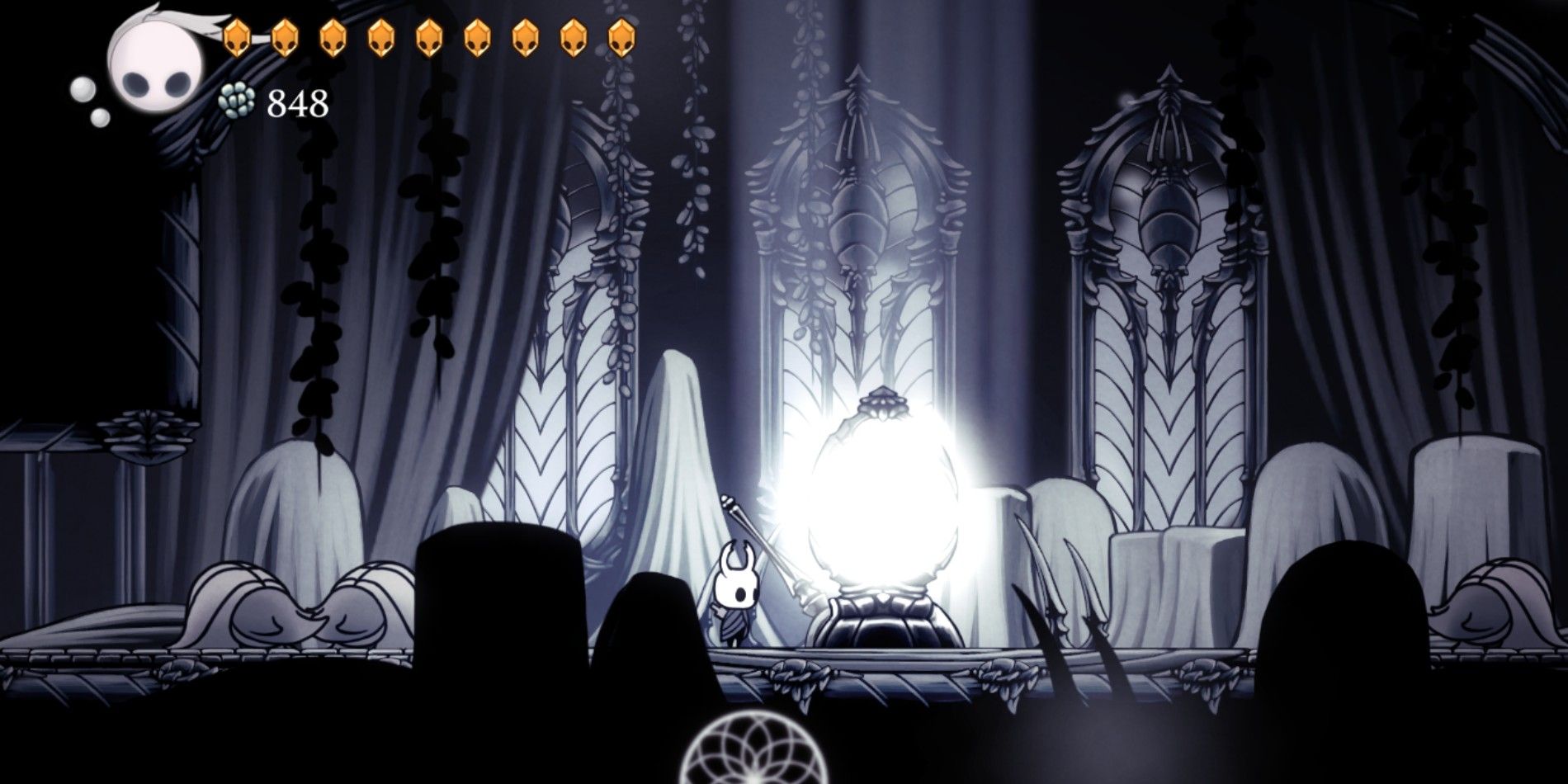 The knight in Hollow Knight standing by a lamp in the White Palace