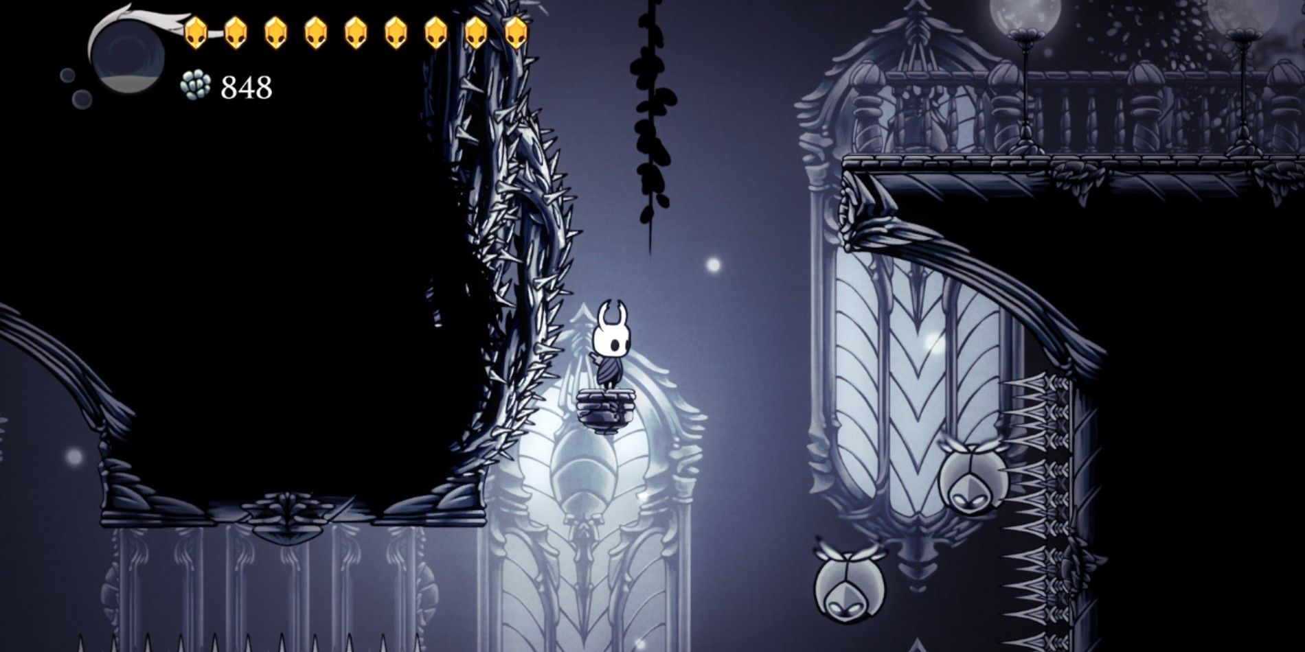 The Knight of Hollow Knight standing on a platform in the White Palace