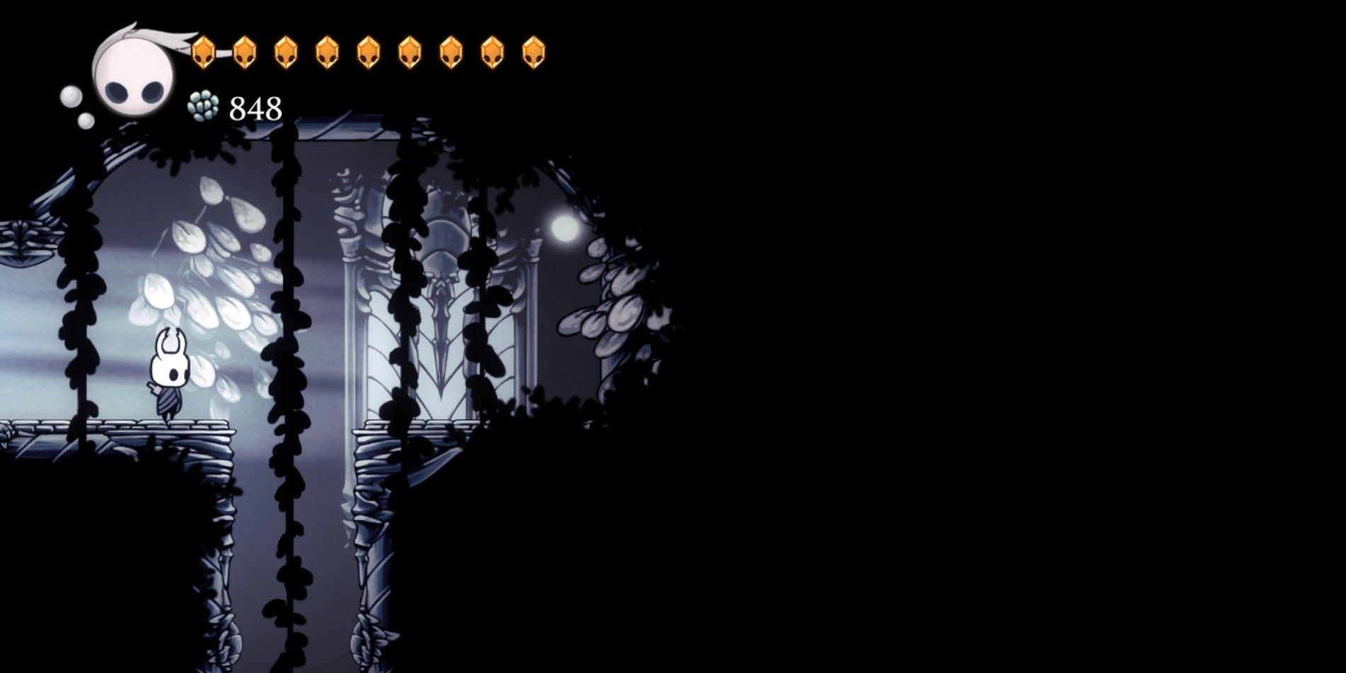 The Knight in Hollow Knight standing near a gap in the White Palace