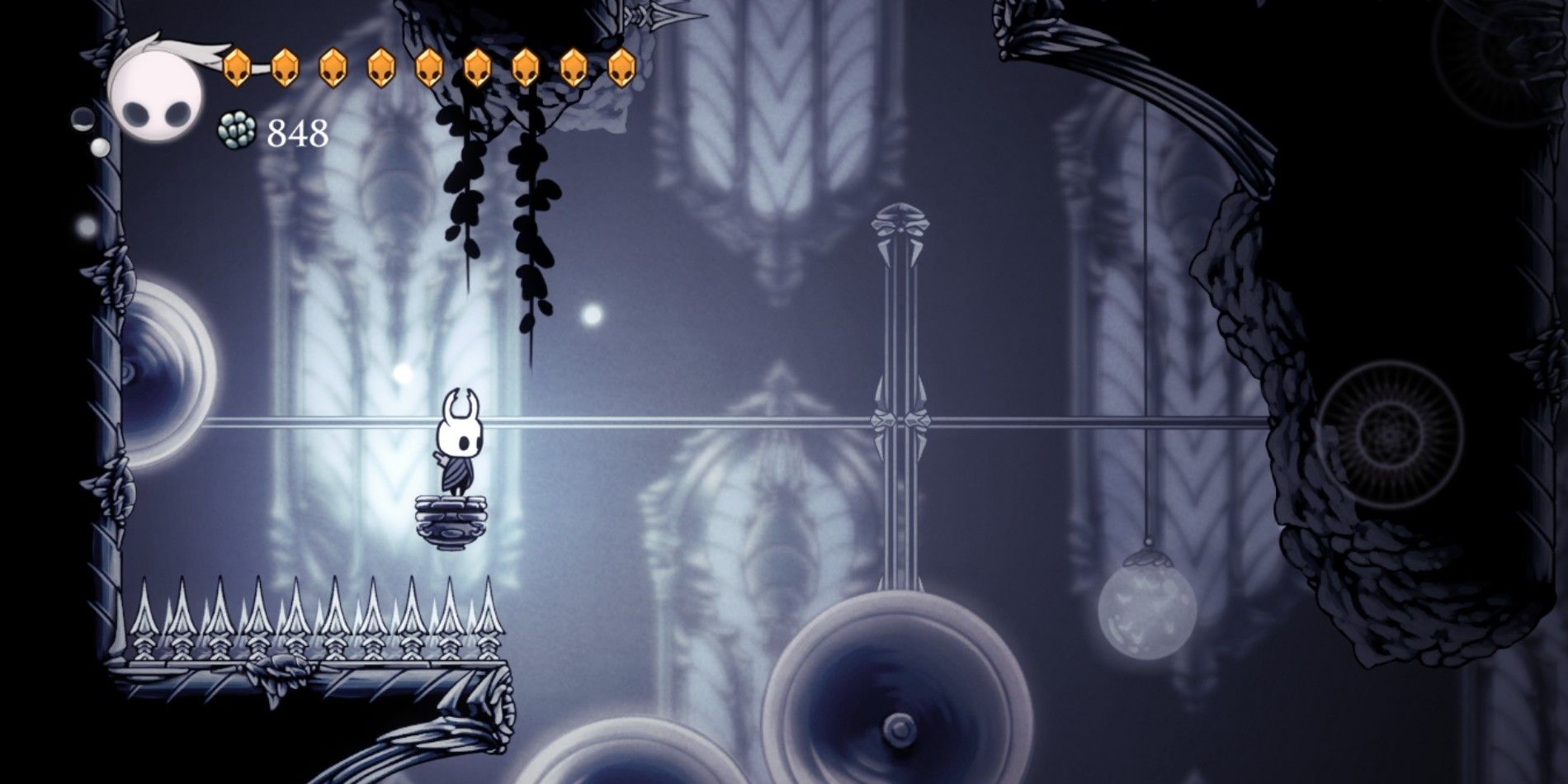 The Knight in Hollow Knight standing on a platform in the White Palace