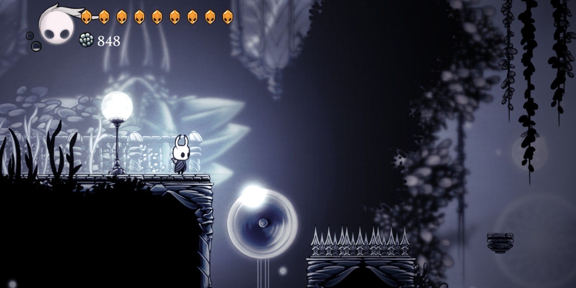 The Knight in Hollow Knight standing on a platform in the White Palace