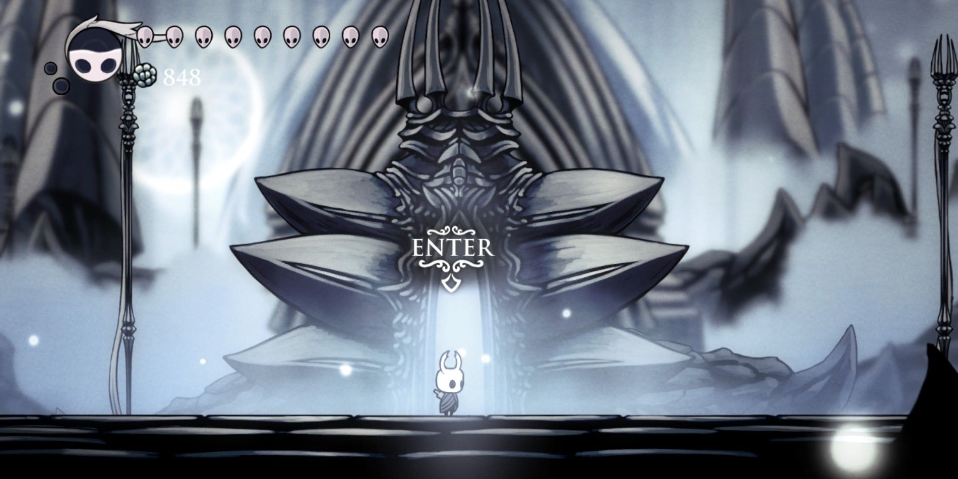 The Knight in Hollow Knight standing by the entrance to the white palace