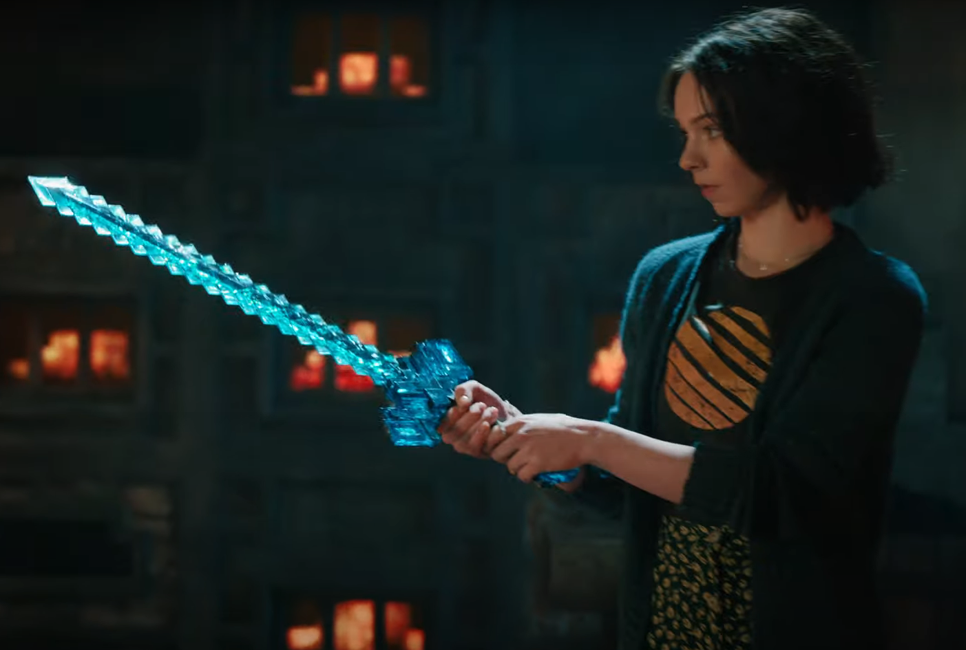 Shot from A Minecraft Movie showing Natalie crafting a diamond sword