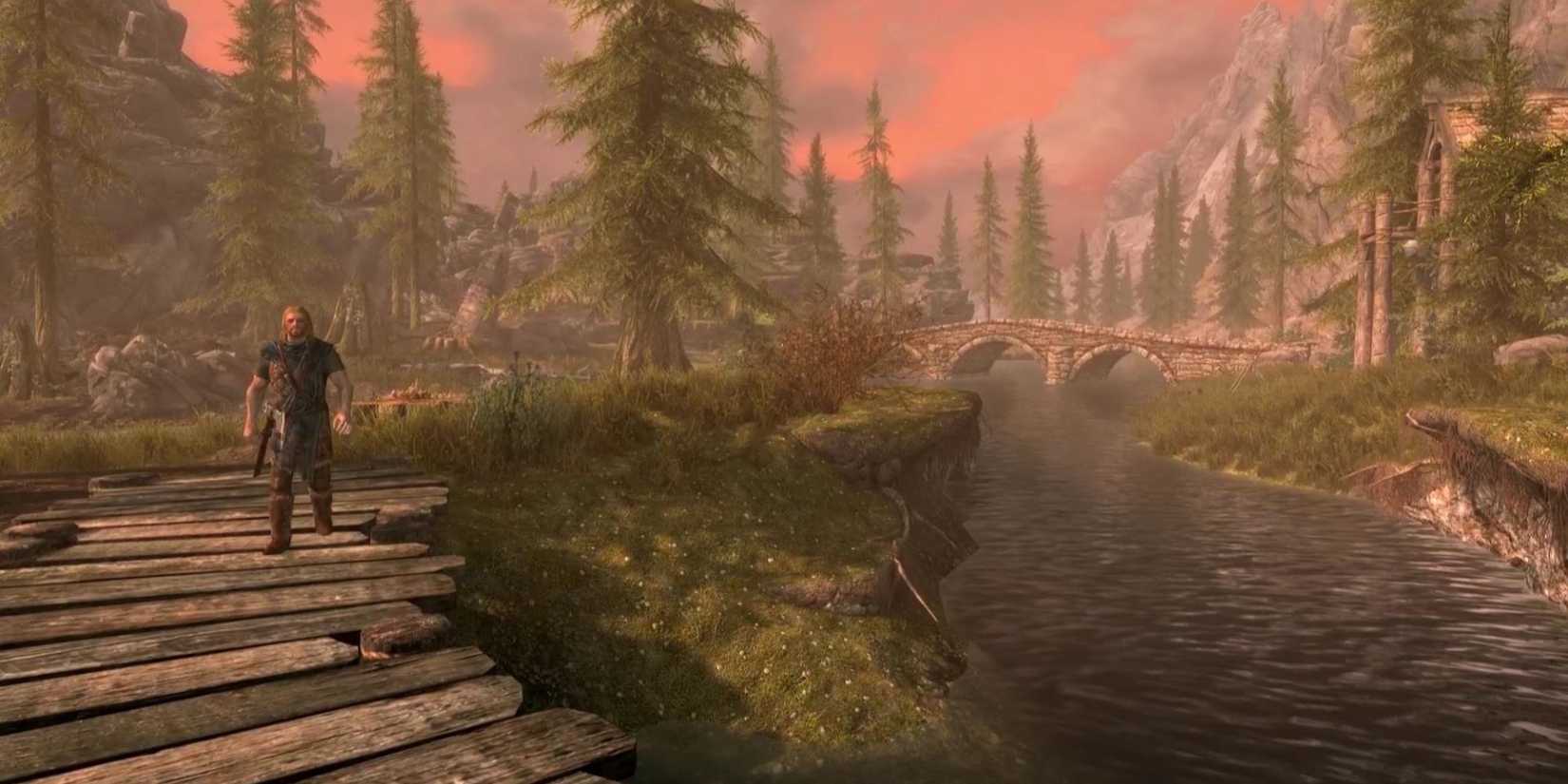 The bridge out of Riverwood sits in the distance in Skyrim.