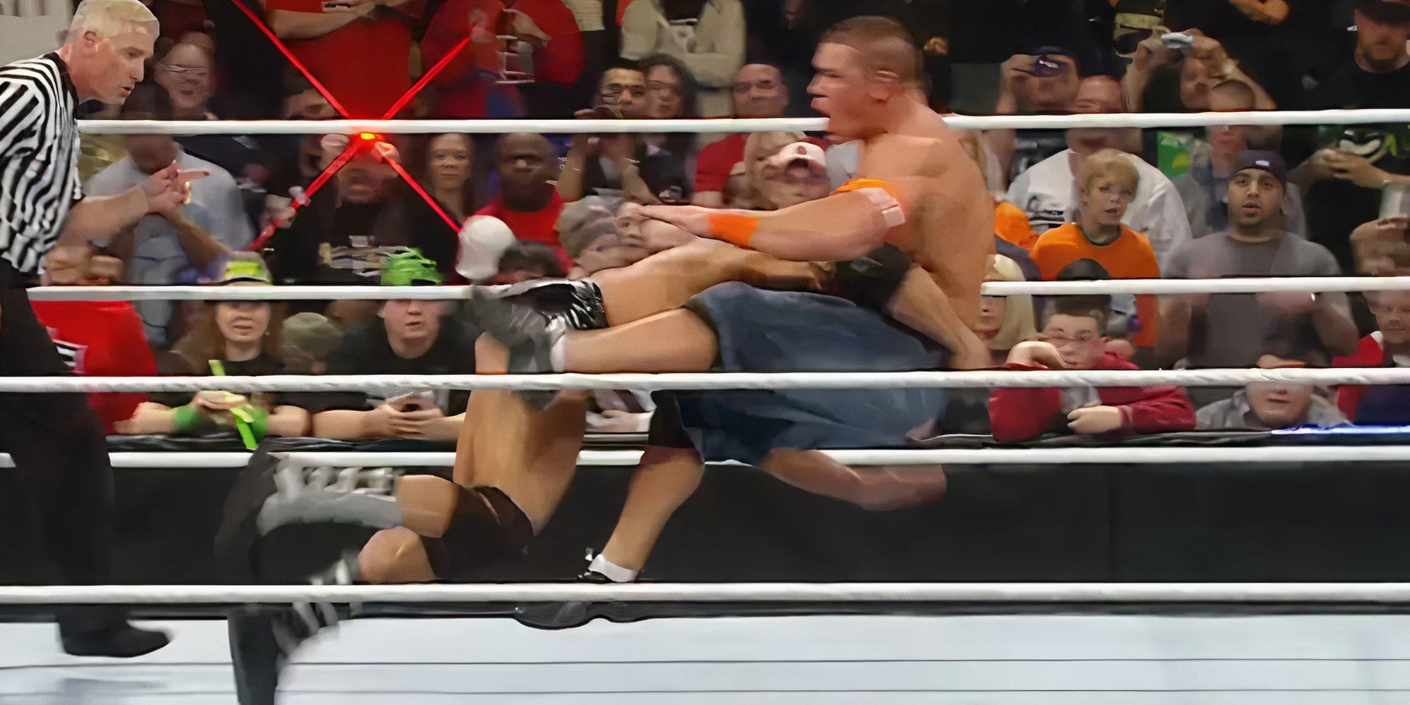 Batista hits a spear on John Cena.