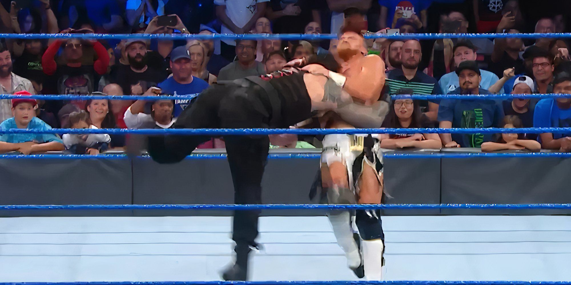 Roman Reigns hits a spear on Buddy Murphy.