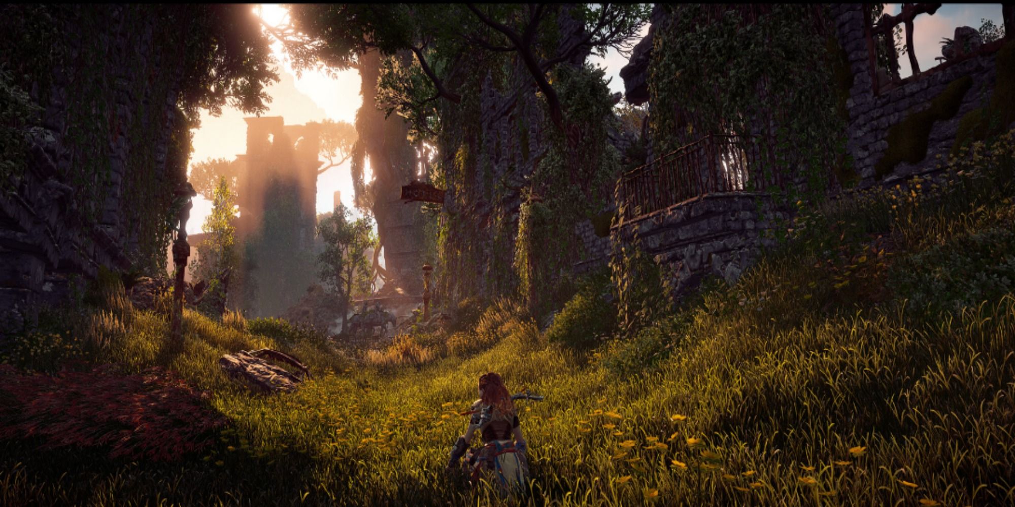 Aloy standing in the tall grass of the fields of Horizon Zero Dawn.